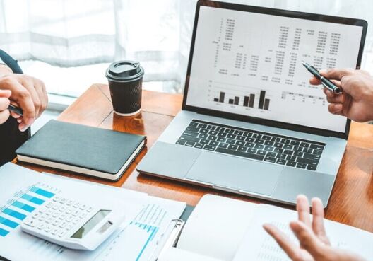 Accounting team using its accounting software to review and generate reports in a meeting