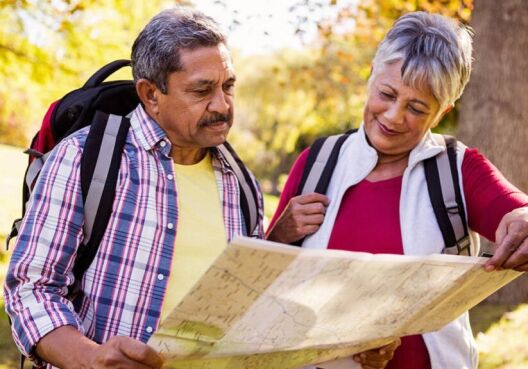 Mature hiking couple looking at a map