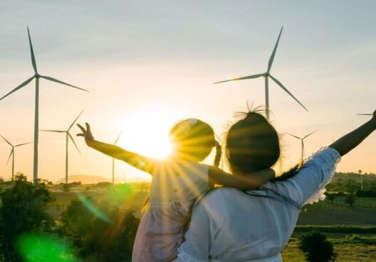 Woman and child viewing energy windmills
